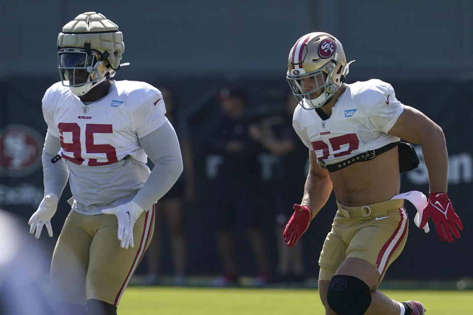 San Francisco 49ers defensive ends Kentavius Street, left, and Nick Bosa warm up at NFL football training camp in Santa Clara, Calif., Tuesday, Aug. 10, 2021. (AP Photo/Jeff Chiu)