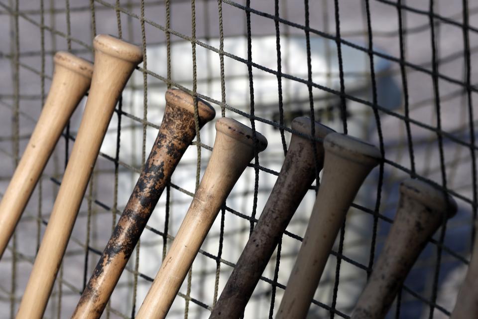 Wooden bats are lined up at the Chatham Anglers' dug out during a Cape Cod League baseball game against the Bourne Braves, Wednesday, July 12, 2023, in Bourne, Mass. For 100 years, the Cape Cod League has given top college players the opportunity to hone their skills and show off for scouts while facing other top talent from around the country. (AP Photo/Michael Dwyer)