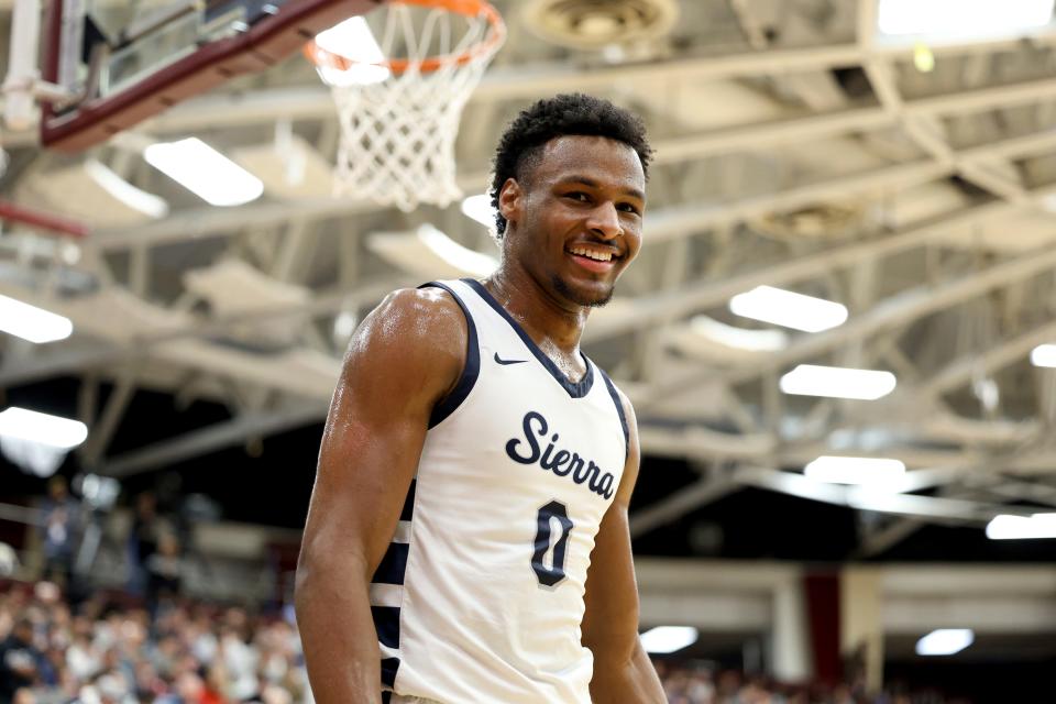 Bronny James smiles during a high school basketball game. James was expected to play for USC this fall and eventually be drafted into the NBA. He had a sudden cardiac arrest during a workout Monday.