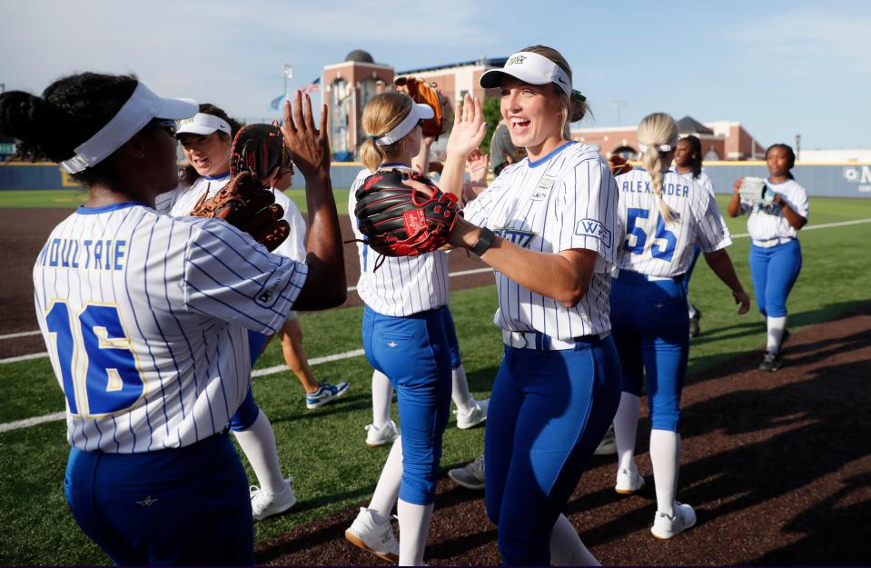 Oklahoma City's Alex Storako slaps hands with teammates before the Women's Professional Fastpitch softball league opening game between Oklahoma City Spark and the Smash It Sports Vipers at the University of Central OklahomaÕs Gerry Pinkston Stadium in Edmond, Thursday, June 15, 2023.