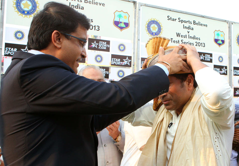 Saurav Ganguly presents Sachin Tendulkar with turban during day three of the first Star Sports test match between India and The West Indies held at The Eden Gardens Stadium in Kolkata, India on the 8th November 2013. (BCCI Photo)