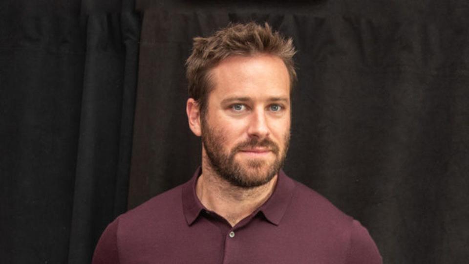 armie hammer wearing a maroon shirt