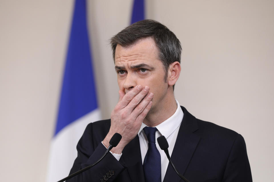 FILE - In this March 28, 2020 file photo, French Minister for Solidarity and Health Olivier Veran speaks during a press conference in Paris. French police searched the homes of the former prime minister, the current and former health ministers and other top officials Thursday in an investigation into the government response to the global coronavirus pandemic. The Health Ministry confirmed the dawn searches, which included the offices of the current health minister Olivier Veran. (Geoffroy van Der Hasselt, Pool via AP)