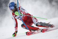 Austria's Marco Schwarz speeds down the course during an alpine ski, men's World Cup slalom, in Lenzerheide, Switzerland, Sunday, March 21, 2021. (AP Photo/Gabriele Facciotti)