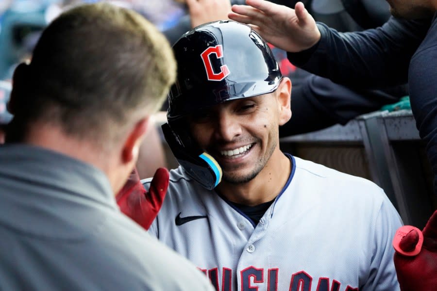 Cleveland Guardians’ Andres Gimenez is greeted in the dugout after hitting a two-run home run against the Chicago Cubs during the third inning of a baseball game game Sunday, July 2, 2023, in Chicago. (AP Photo/David Banks)