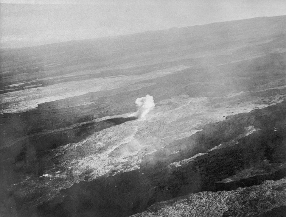 This photo provided by the United States Army Air Corps shows an aerial view of a bomb detonating on Mauna Loa near the 8500-foot elevation source of the 1935 lava flow on the morning of Dec. 27, 1935. Now Mauna Loa — the world's largest active volcano — is erupting again, and lava is slowly approaching a major thoroughfare connecting the Big Island's east and west sides. (United States Army Air Corps, 11th Photo Section via AP)