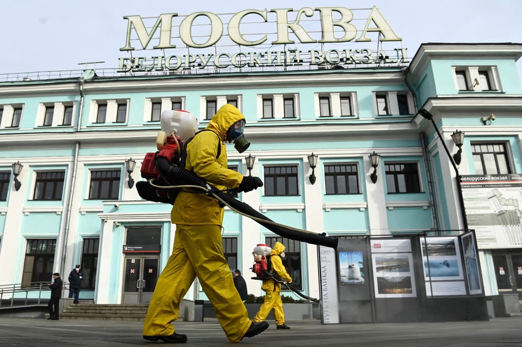 Workers from Russia’s Emergencies Ministry, wearing protective gear, disinfect Moscow’s Belorussky railway station earlier this week (AFP via Getty Images)