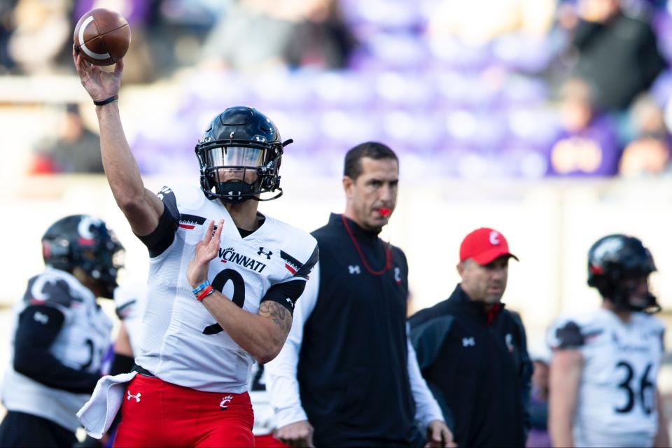 University of Cincinnati's quarterback Desmond Ridder warms-up before the Bearcats faces East Carolina in Greenville, North Carolina Friday, November 26, 2021.