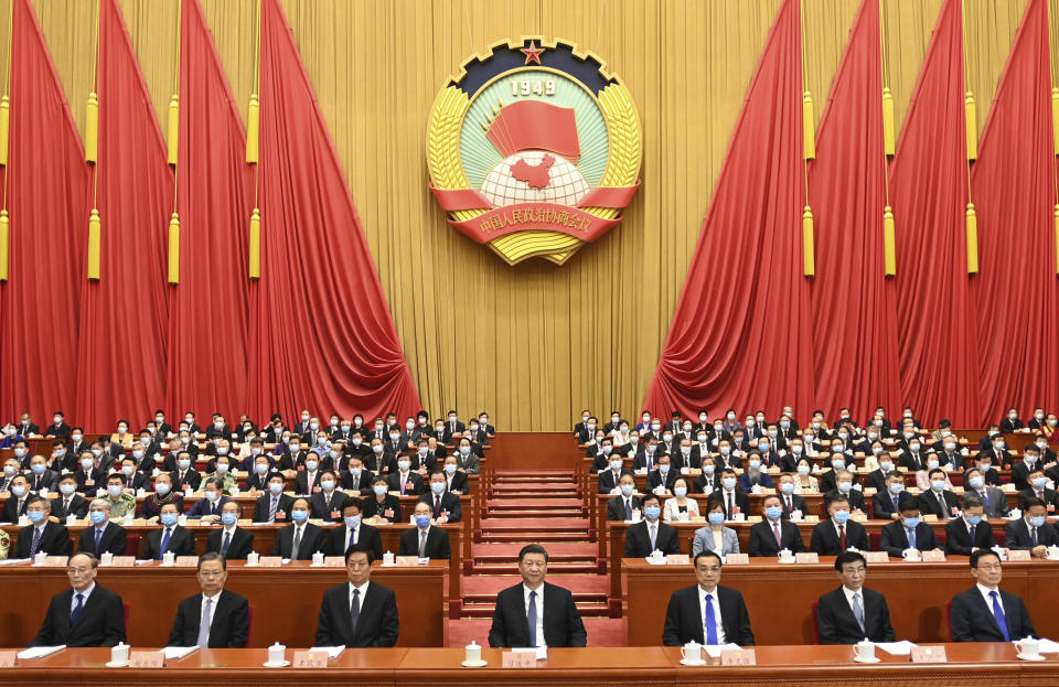 In this photo released by Xinhua News Agency, Chinese President Xi Jinping, center, attends the opening session of the Chinese People's Political Consultative Conference (CPPCC) at the Great Hall of the People in Beijing, Thursday, May 21, 2020. (Li Xueren/Xinhua via AP)