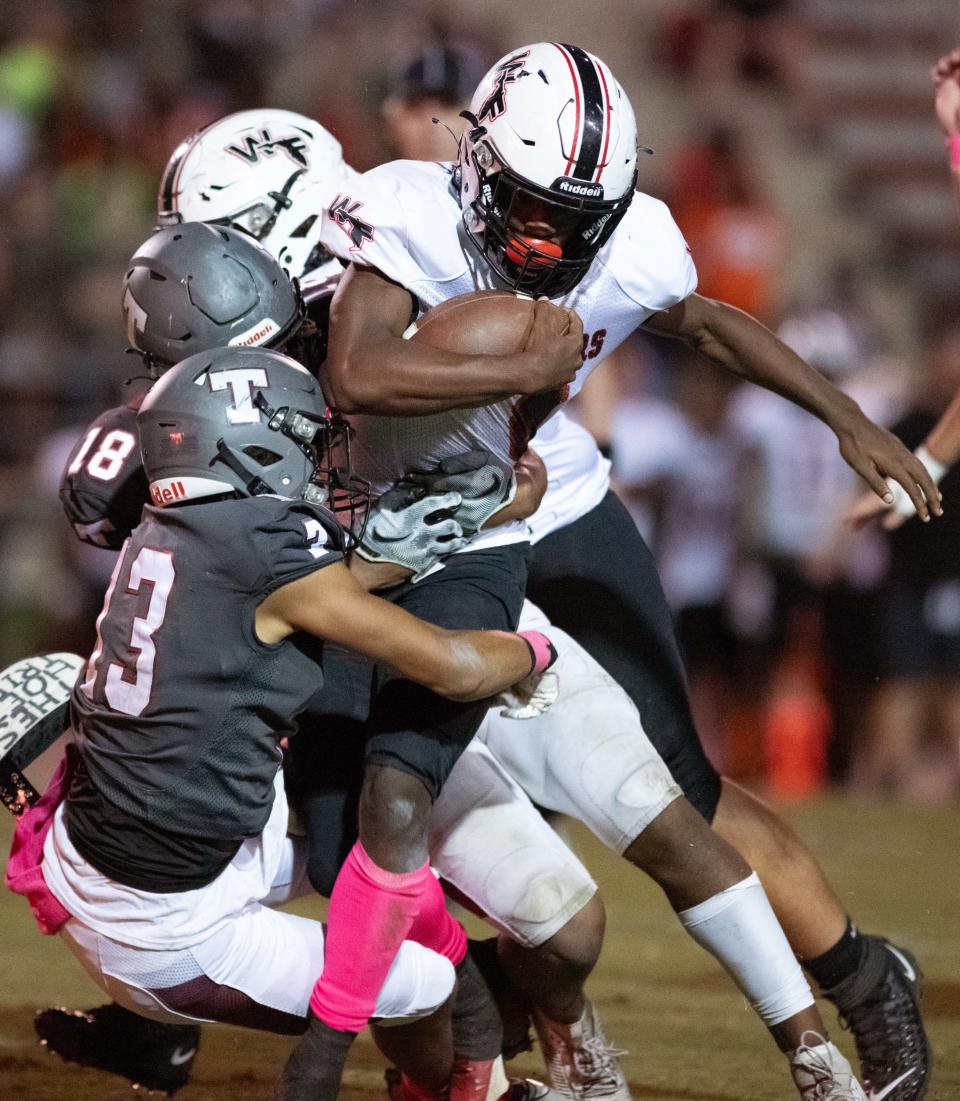 Marquez Jones (4) carries the ball during the West Florida vs Tate football game at Tate High School in Cantonment on Friday, Oct. 6, 2023.