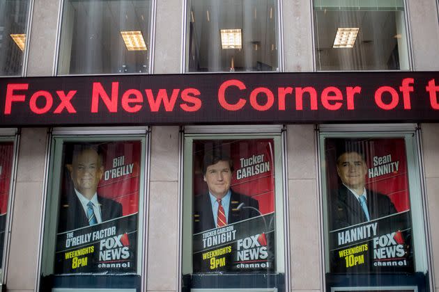 Fox News Channel personalities are displayed at the News Corp. headquarters in New York in 2017. Former top-rated host Tucker Carlson (center) was fired from the network in April, leading to a downfall in ratings. The network’s other former top-rated host, Bill O’Reilly (left), was fired in 2017 after the disclosure of a series of sexual harassment allegations against him.