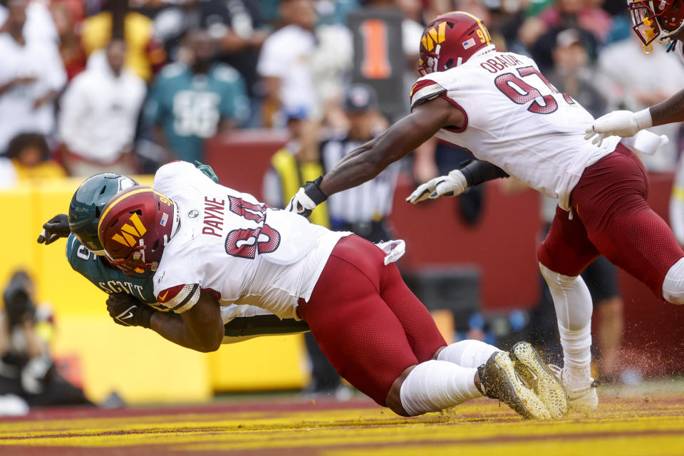 Washington Commanders defensive tackle Daron Payne (94) tackles Philadelphia Eagles running back Boston Scott (35) for a safety during the second half of a NFL football game between the Washington Commanders and the Philadelphia Eagles on Sunday, Sept. 25, 2022 at FedExField in Landover, Md. (Shaban Athuman/Richmond Times-Dispatch via AP)