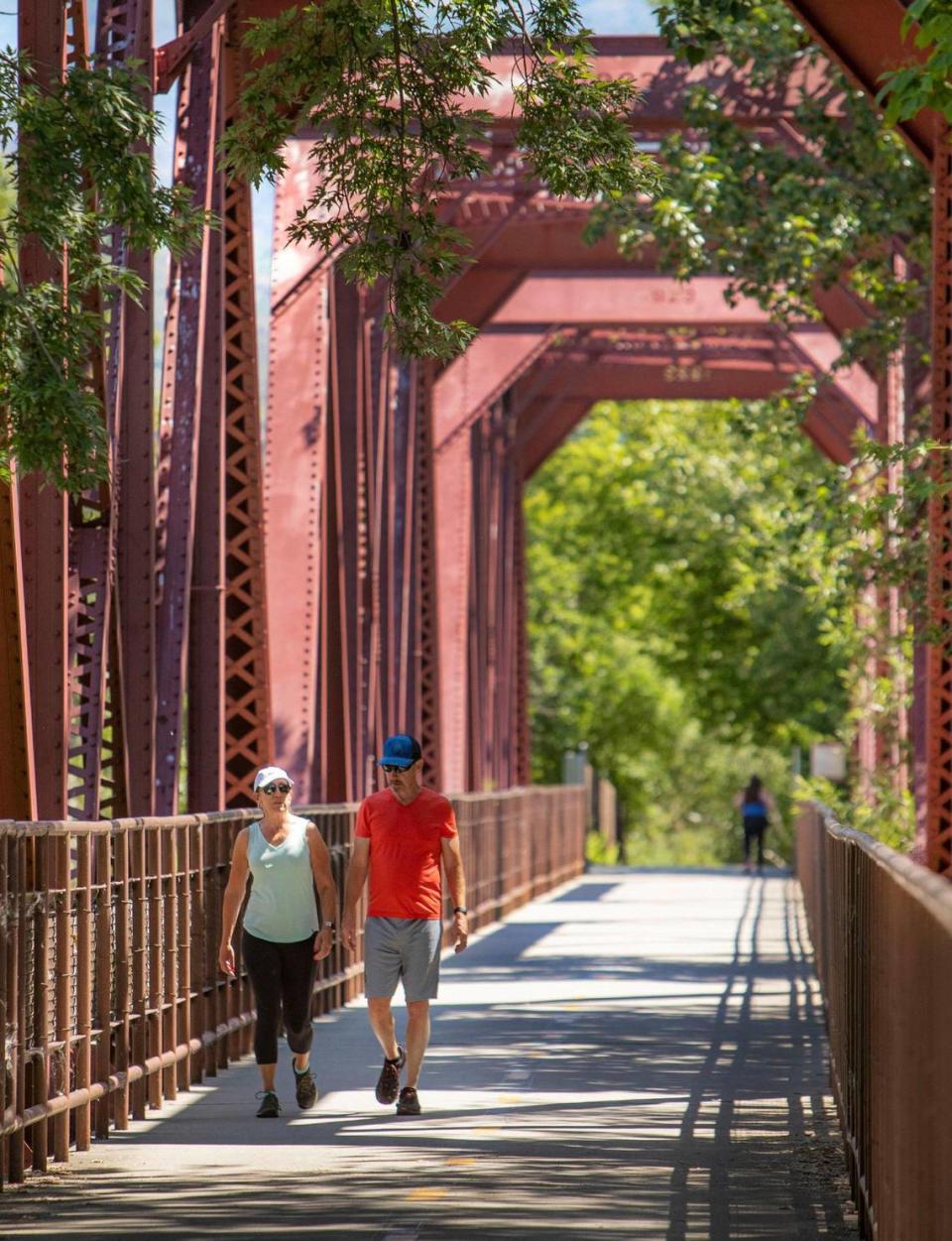 A pair of people relax with a walk along the Boise Greenbelt.