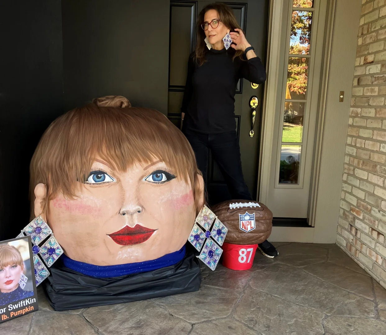 Artist Jeanette Paras with "Taylor Swiftkin," a 399-pound pumpkin she designed, painted and decorated to resemble musical artist  Taylor Swift, on Tuesday, Oct. 24, 2023 on the front porch of her Dublin home.