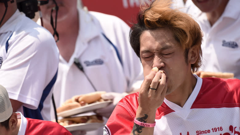 Contestant eating hot dogs