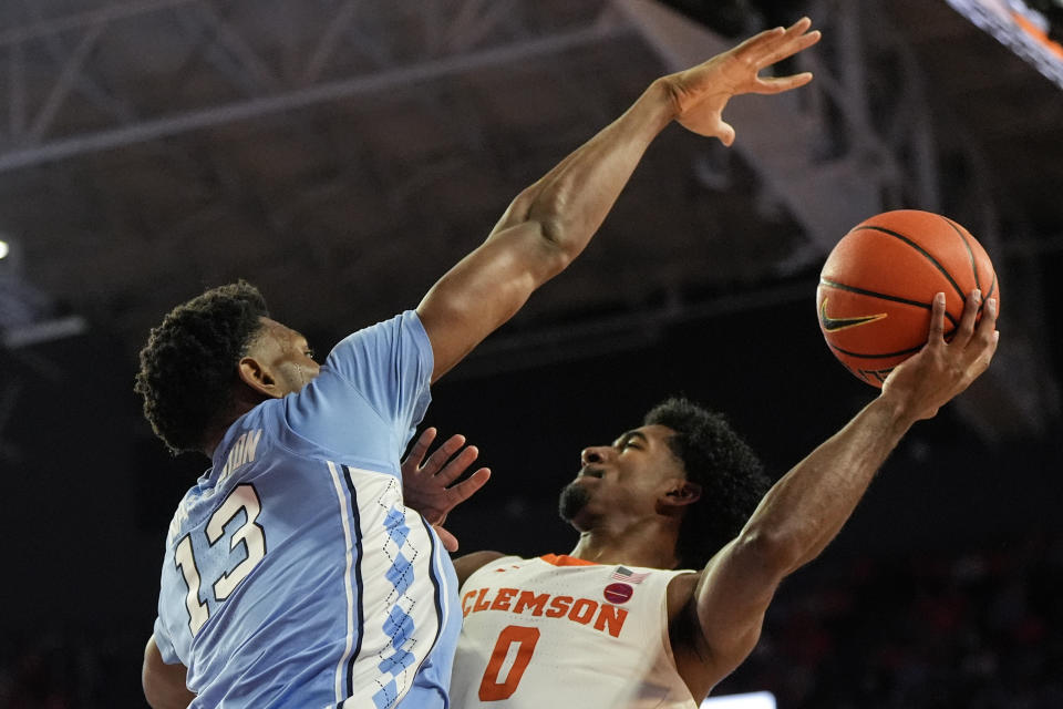 Clemson guard Josh Beadle (0) shoots against North Carolina forward Jalen Washington (13) during the first half of an NCAA college basketball game, Saturday, Jan. 6, 2024, in Clemson, S.C. AP Photo/Mike Stewart)