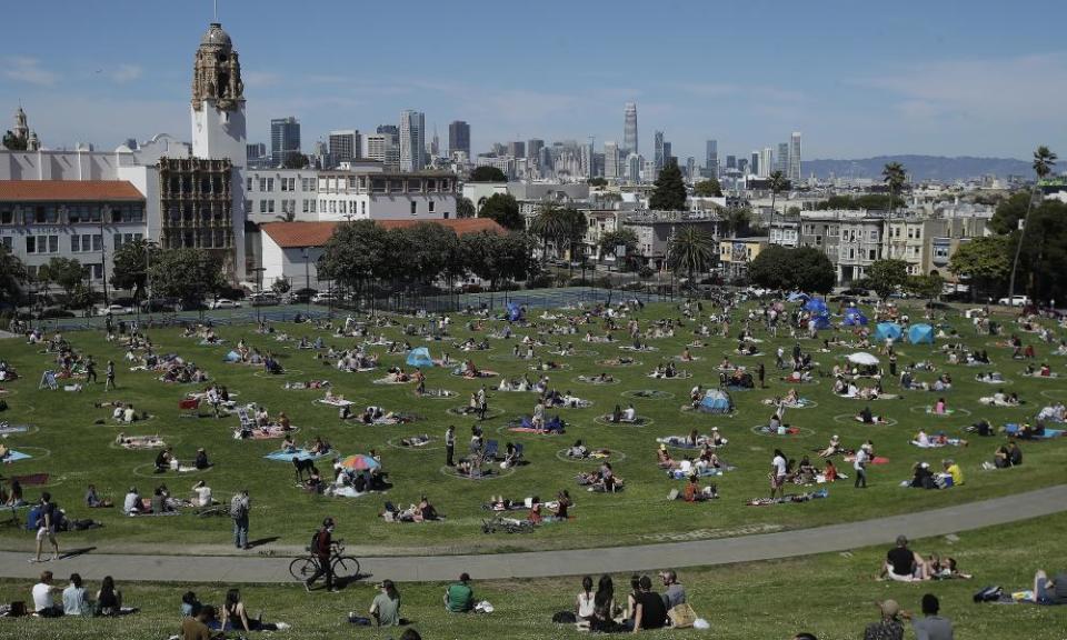 Visitors set up inside circles designed to help prevent the spread of the coronavirus by encouraging social distancing at Dolores Park in San Francisco in May 2020 (AP Photo/Jeff Chiu, File)