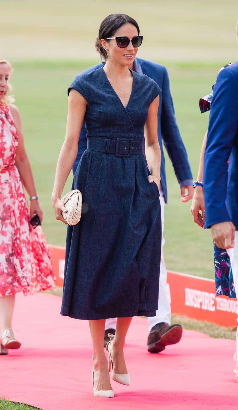 <p>For a casual day watching Prince Harry play polo, Meghan chose a belted navy blue Carolina Herrera dress, and paired it with statement sunglasses, nude pumps, and an affordable rattan clutch from J.Crew.</p><p><a class="link " href="https://go.redirectingat.com?id=74968X1596630&url=https%3A%2F%2Fwww.jcrew.com%2Fp%2Fwomens_category%2Fhandbags%2Fstraw%2Ffan-rattan-clutch%2FJ0146&sref=https%3A%2F%2Fwww.townandcountrymag.com%2Fstyle%2Ffashion-trends%2Fg3272%2Fmeghan-markle-preppy-style%2F" rel="nofollow noopener" target="_blank" data-ylk="slk:Shop the Clutch;elm:context_link;itc:0;sec:content-canvas">Shop the Clutch</a><br></p>