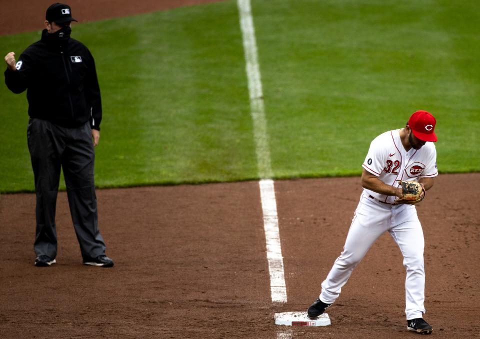 Cincinnati Reds second baseman Max Schrock (32) reacts to getting a triple play as the base runner failed to tag up in the eighth inning of the MLB baseball game between Cincinnati Reds and Cleveland Indians at Great American Ball Park in Cincinnati on Saturday, April 17, 2021. 