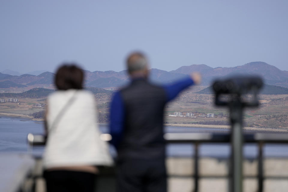 Visitors look at the North Korea side from the unification observatory in Paju, South Korea, Friday, April 15, 2022. North Korea is marking a key state anniversary Friday with calls for stronger loyalty to leader Kim Jong Un, but there was no word on an expected military parade to display new weapons amid heightened animosities with the United States. (AP Photo/Lee Jin-man)