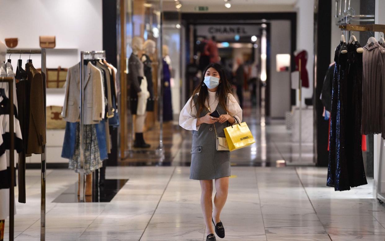 A shopper at Selfridges in June - AFP