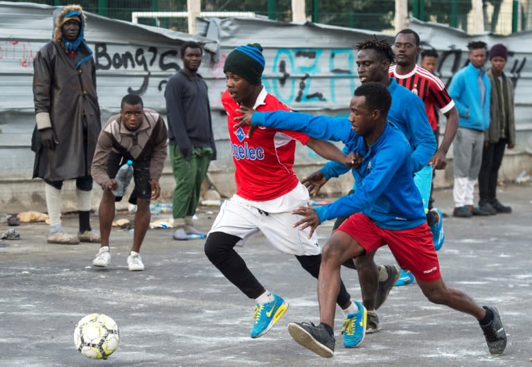 Sub-Saharan migrants play football on a makeshift football pitch at the Oulad Ziane migrant camp in Casablanca on February 19, 2018