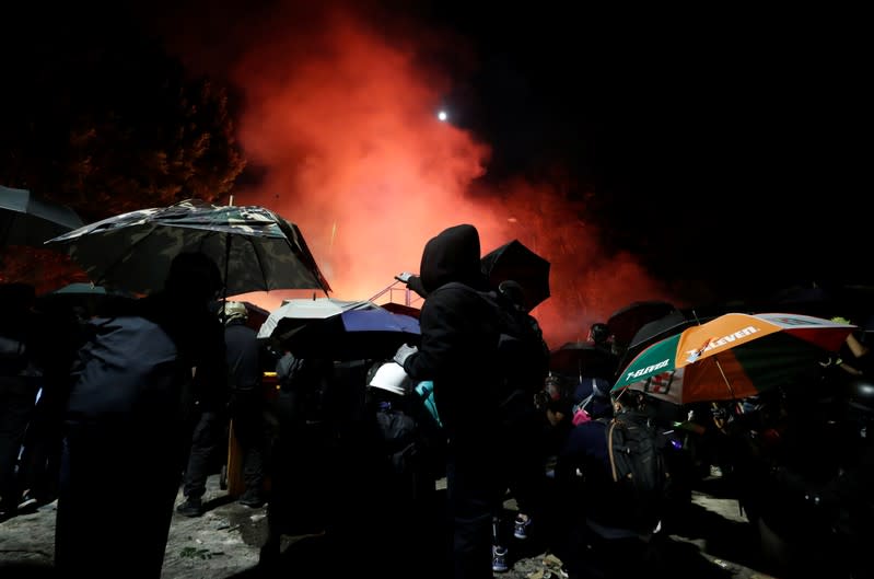 A protesters throws a molotov cocktail during a standoff with riot police at the Chinese University of Hong Kong