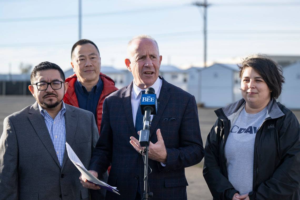 Mayor Darrell Steinberg, center, addresses the media at a press conference at the homeless shelter on Roseville Road on Jan. 5 in North Sacramento. The new site will include 40 trailers and 60 Pallet tiny homes for up to 240 people.