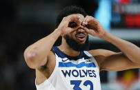 Minnesota Timberwolves center Karl-Anthony Towns gestures to the bench as a timeout is called in the first half of Game 1 of an NBA basketball second-round playoff series against the Denver Nuggets, Saturday, May 4, 2024, in Denver. (AP Photo/David Zalubowski)
