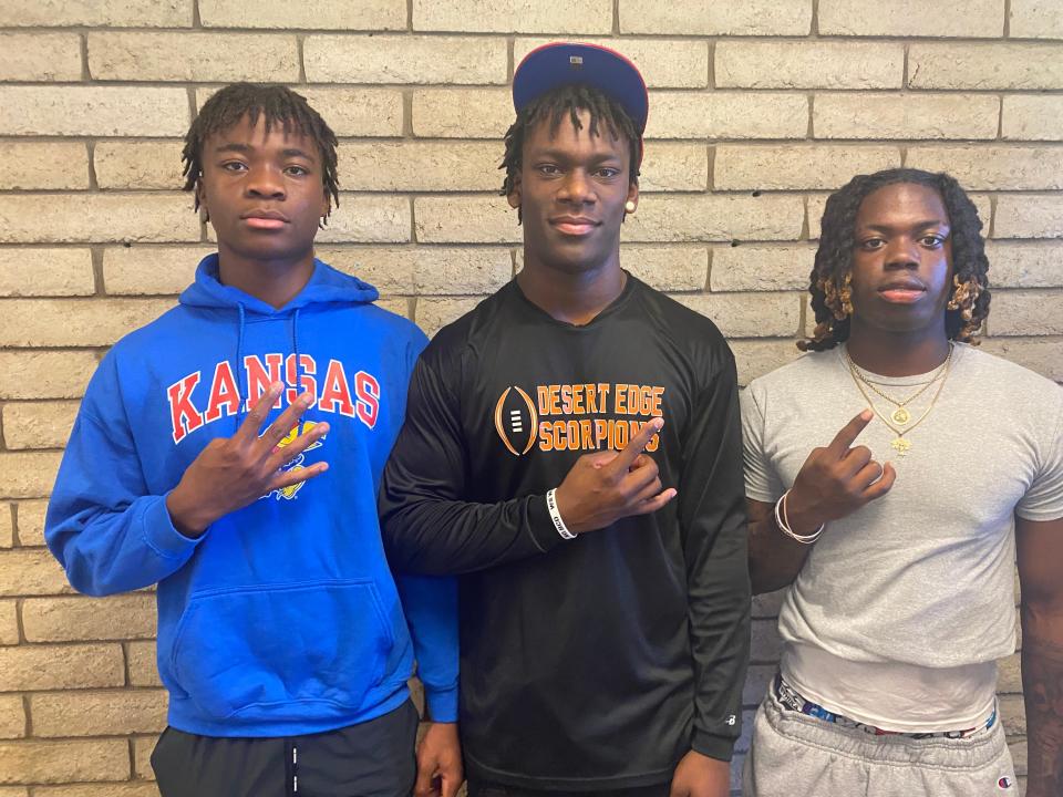 Desert Edge edge rusher Deshawn Warner (center), flanked by OLB/S Jonathan Kamara (left) and cornerback Aundre Gibson all have committed to the Kansas Jayhawks for football