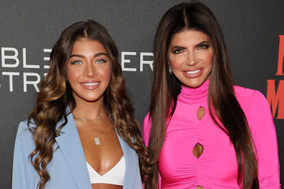 Teresa and Gia stand together while posing on a red carpet