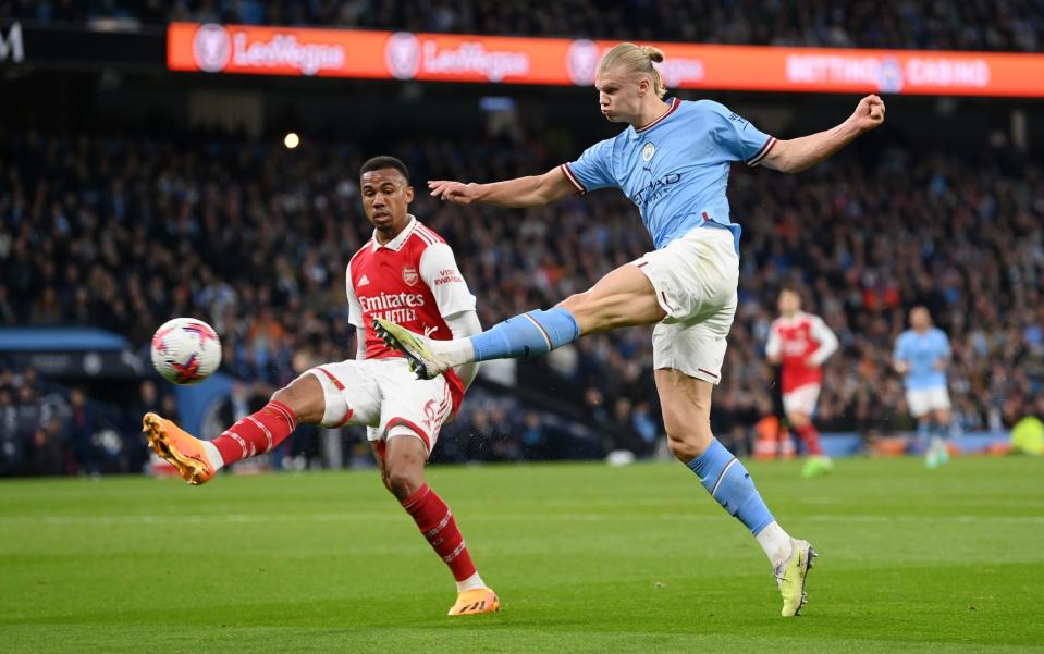 Erling Haaland of Manchester City shoots past Gabriel of Arsenal - Michael Regan/Getty Images