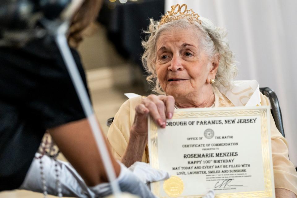 Rosemarie Menzies celebrates her 100th birthday with a Great Gatsby themed party at Harmony Village at CareOne Paramus on Friday, August 11, 2023. Menzies holds a certificate issued by the Paramus Mayor.