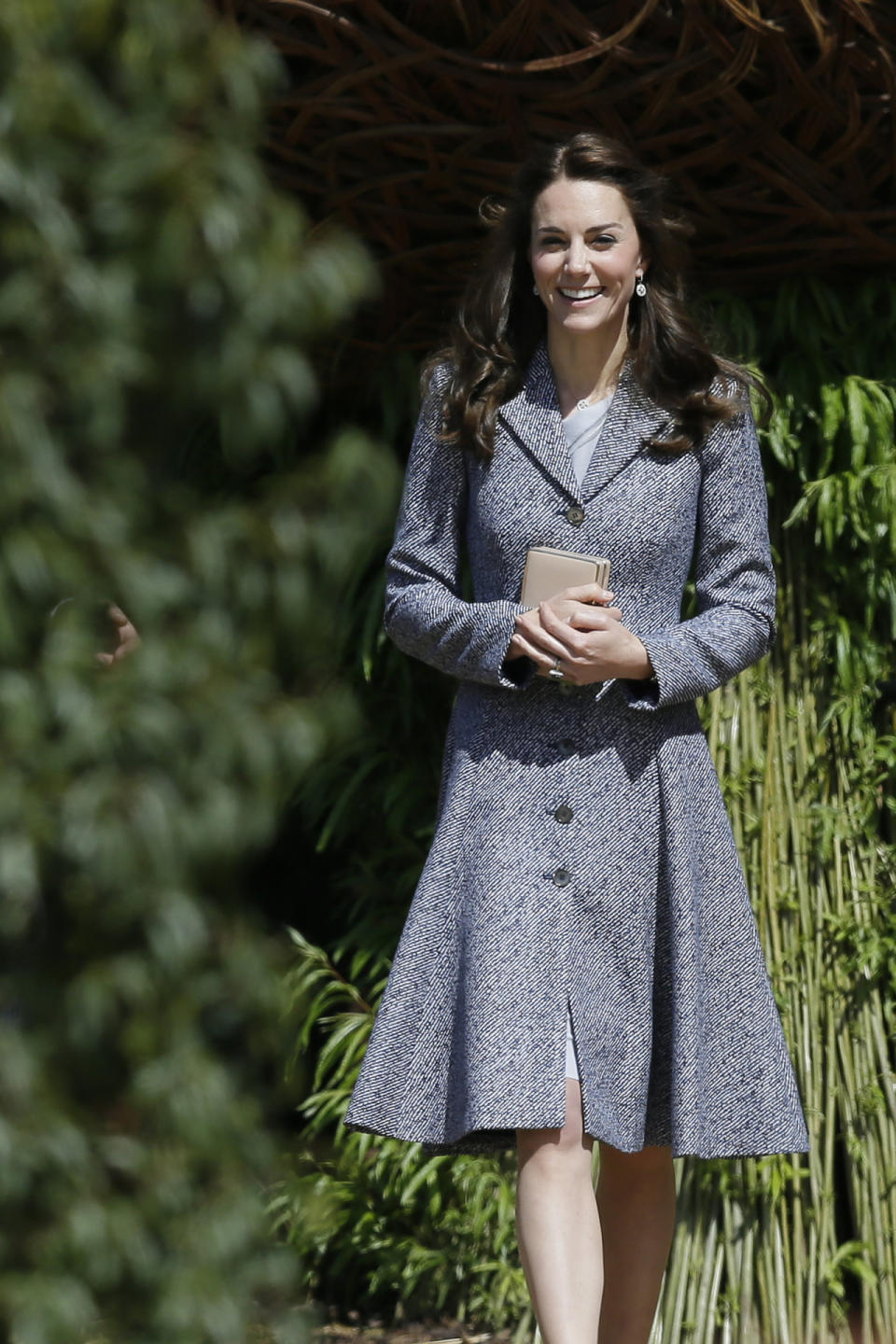 The Duchess of Cambridge in a Michael Kors coat and during a garden tour at Hampton Court Palace in London.