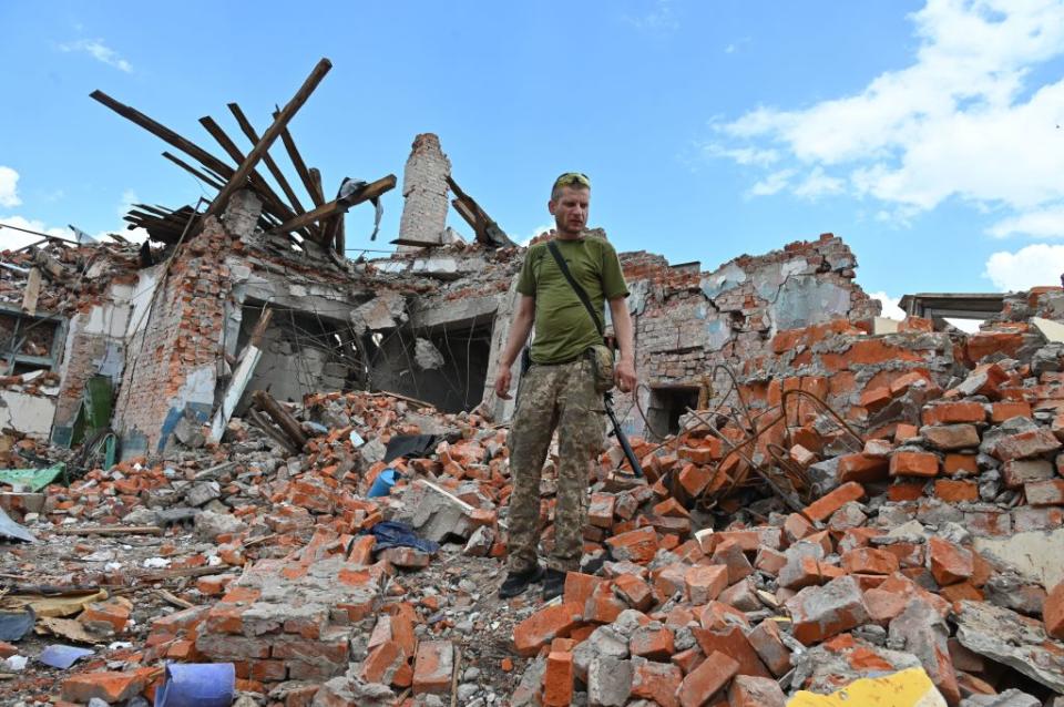 A Ukrainian serviceman inspects the ruins of Lyceum building, after a suspected missile strike near Kharkiv on July 5, 2022.<span class="copyright">Sergey Bobok—AFP via Getty Images</span>