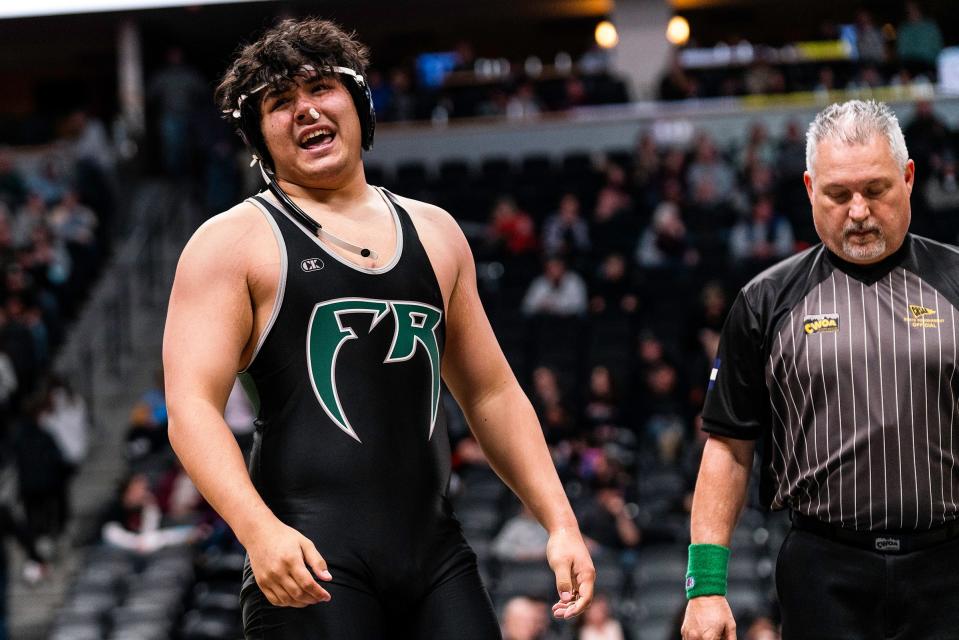 Fossil Ridge's Thomas Iverson celebrates after beating Douglas County's Zach Rusin during the Colorado state wrestling tournament at Ball Arena on Thursday, Feb. 16, 2023 in Denver, Colo.