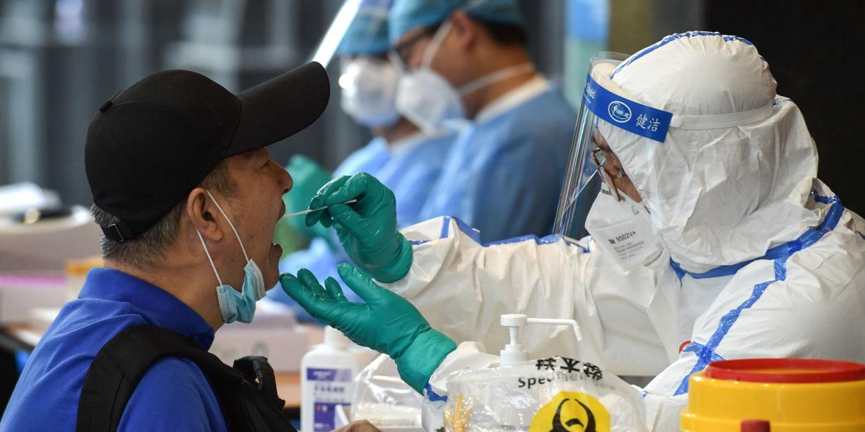 A man, who visited Beijing recently, is tested for the COVID-19 coronavirus in Nanjing in China's eastern Jiangsu province on June 15, 2020. - China's capital city raced on June 15 to control a fresh coronavirus outbreak, with 75 cases linked to a single wholesale food market in Beijing where authorities have locked down neighbourhoods and launched a massive test and trace programme. (Photo by STR / AFP) / China OUT (Photo by STR/AFP via Getty Images)