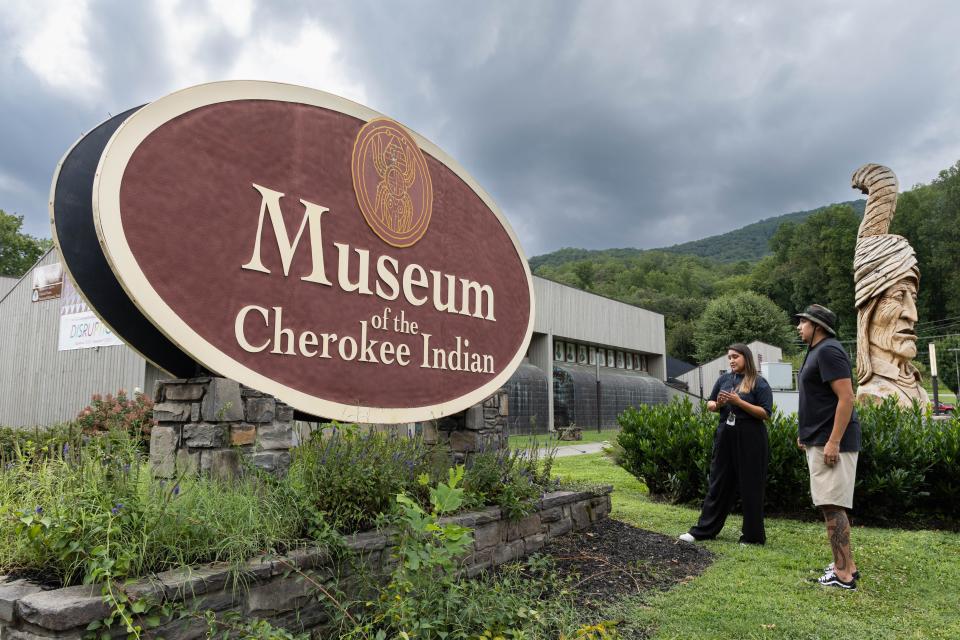 Museum Director of Education Dakota Brown (Eastern Band of Cherokee Indians) and artist Luke Swimmer (Eastern Band of Cherokee Indians) consider the museum’s previous sign.