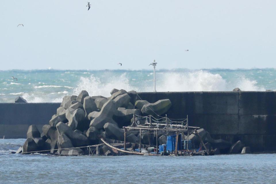 The wreckage of the wooden boat is pictured along a sea wall in the city of Yurihonjo, Akita prefecture in Japan: AFP/Getty Images