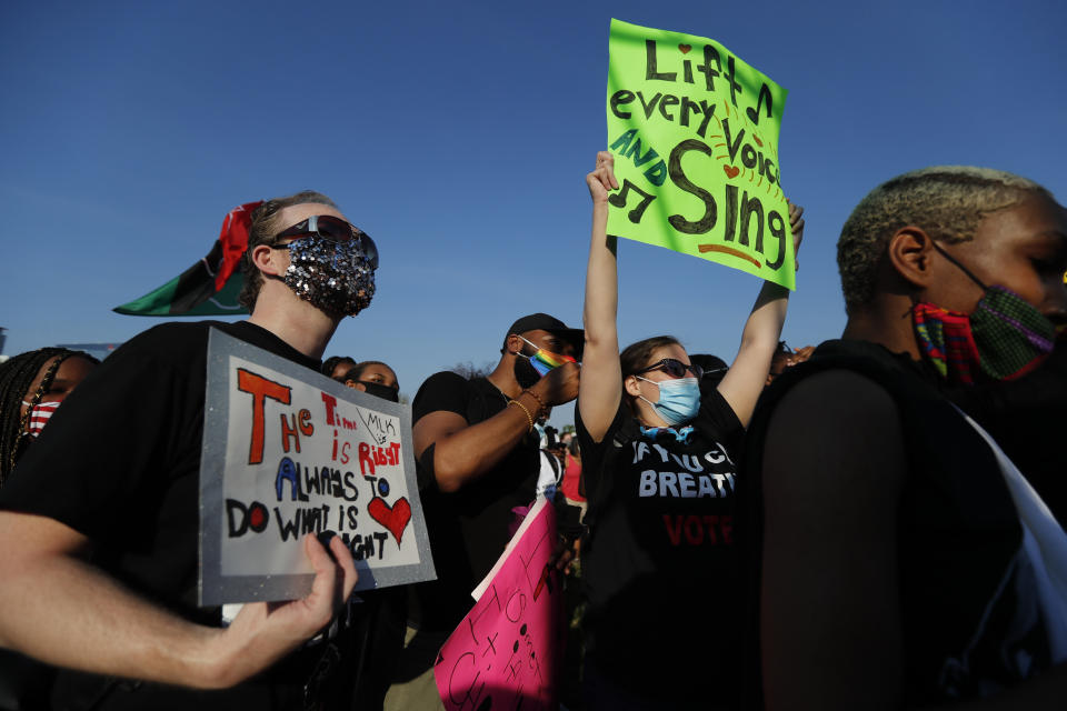 In this June 19, 2020, photo, people attend a peaceful rally in Chicago to mark Juneteenth. The holiday celebrates the day in 1865 that enslaved black people in Galveston, Texas, learned they had been freed from bondage, more than two years after the Emancipation Proclamation. (AP Photo/Charles Rex Arbogast)