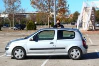 Cristian Lopez poses with his newly-bought 15-year-old second hand car in an empty parking lot in Madrid