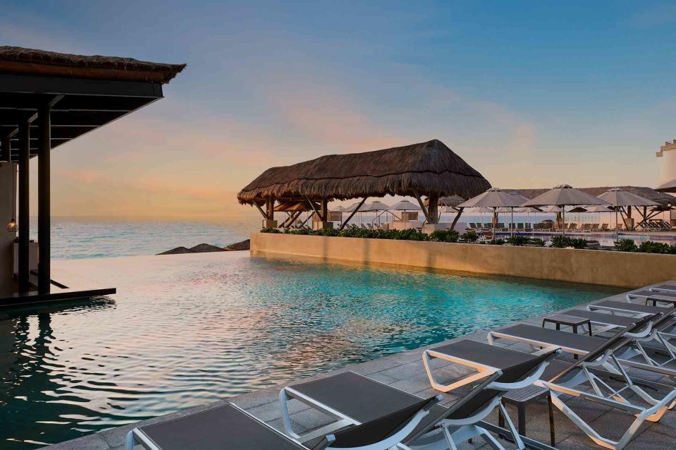 <p>Courtesy of Marriott Cancun, an All-Inclusive Resort</p> Scenic view of the morning over an infinity pool at the Marriott Cancun, an All-Inclusive Resort