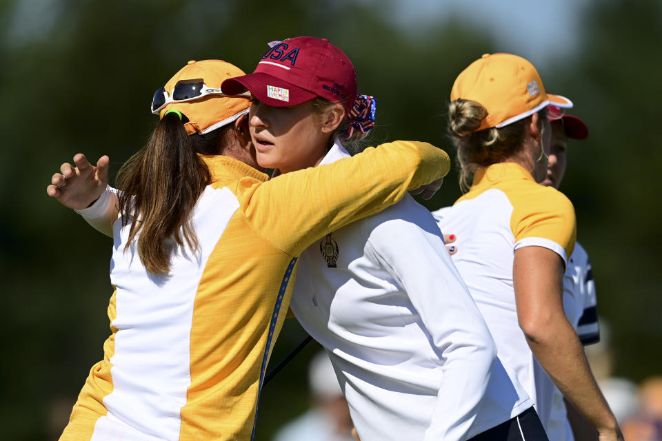 Europe's Leona Maguire hugs United States' Nelly Korda after her win on the 14th hole during the foursome matches at the Solheim Cup golf tournament, Sunday, Sept. 5, 2021, in Toledo, Ohio. (AP Photo/David Dermer).