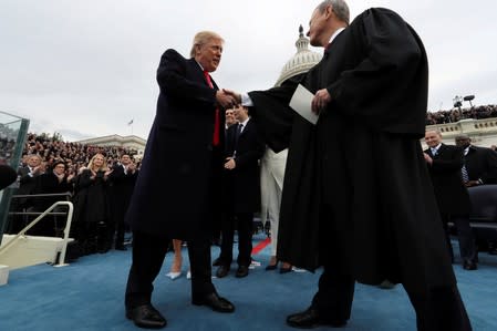 FILE PHOTO: U.S. President Donald Trump and U.S. Supreme Court Chief Justice John Roberts shake hands after Trump took the oath of office in Washington