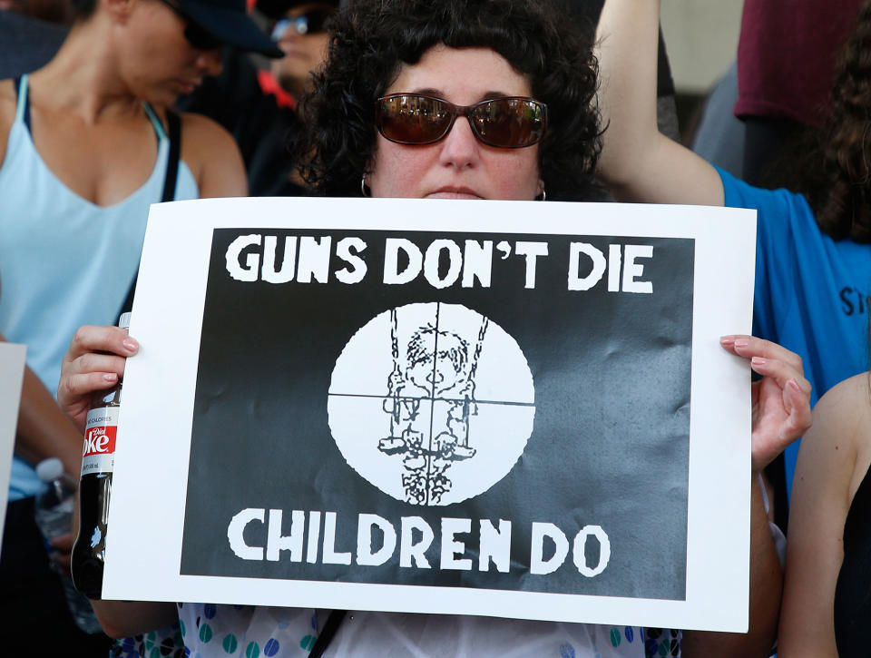 <p>Protesters hold signs at a rally for gun control at the Broward County Federal Courthouse in Fort Lauderdale, Fla., Feb. 17, 2018. (Photo: Rhona Wise/AFP/Getty Images) </p>