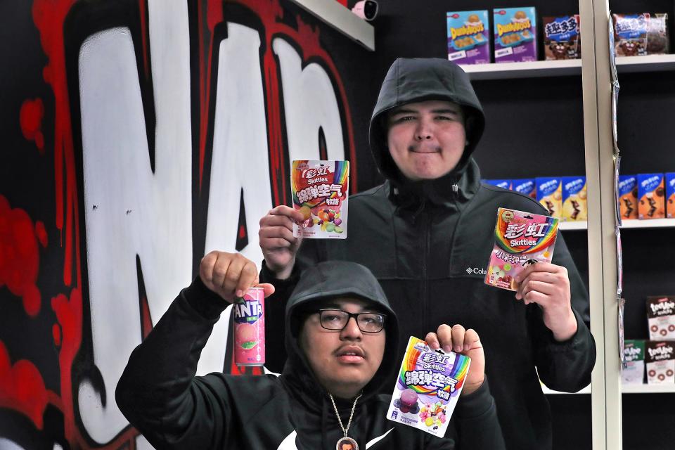 Sergio Salazar, left, and Ruben Olivares show some product from ttheir new business, Nap Snacks, Thursday, Jan. 27, 2022 at 1323 W. 86th St. The cousins opened the store to sell imported snacks and drinks. Many of the items are common brands like Oreos, Lays and Fanta, but the flavors and forms are not sold in the U.S.