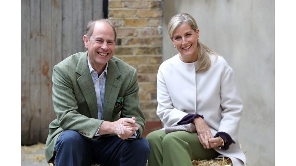 Prince Edward and Sophie smile sat on hay bail