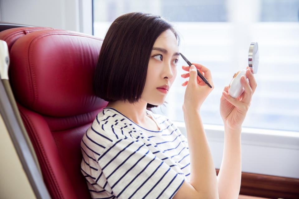 Commuter makeup rituals are a cause of debate for some. [Photo: Getty]
