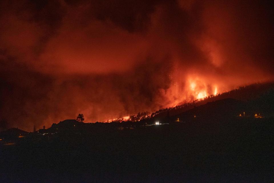 Mount Cumbre Vieja erupts in El Paso, spewing out columns of smoke, ash and lava as seen from Los Llanos de Aridane on the Canary island of La Palma on September 19, 2021. - The Cumbre Vieja volcano erupted on Spain's Canary Islands today spewing out lava, ash and a huge column of smoke after days of increased seismic activity, sparking evacuations of people living nearby, authorities said. Cumbre Vieja straddles a ridge in the south of La Palma island and has erupted twice in the 20th century, first in 1949 then again in 1971. (Photo by DESIREE MARTIN / AFP) (Photo by DESIREE MARTIN/AFP via Getty Images)