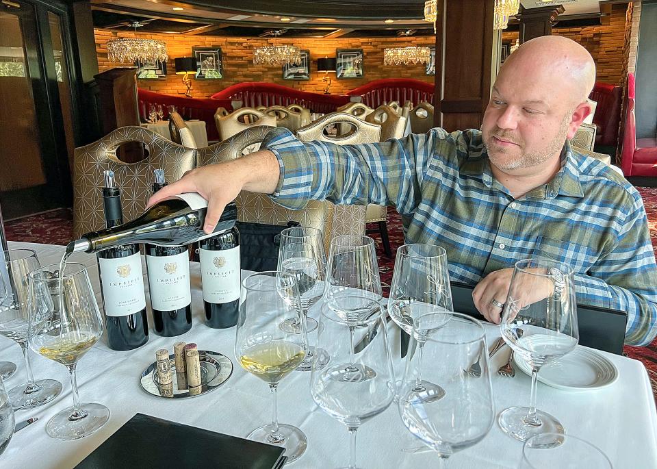 Implicit Cellars co-owner Tony Granata pours a glass of their Avidity Chardonnay at Lanning's Restaurant.